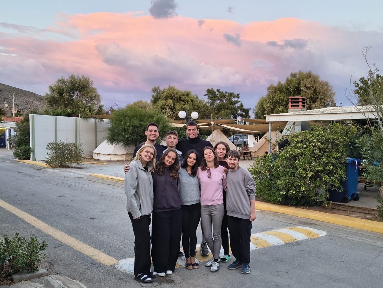 Part of the Y-Cycle group at the campsite on Elafonisos, under a pink sunset sky