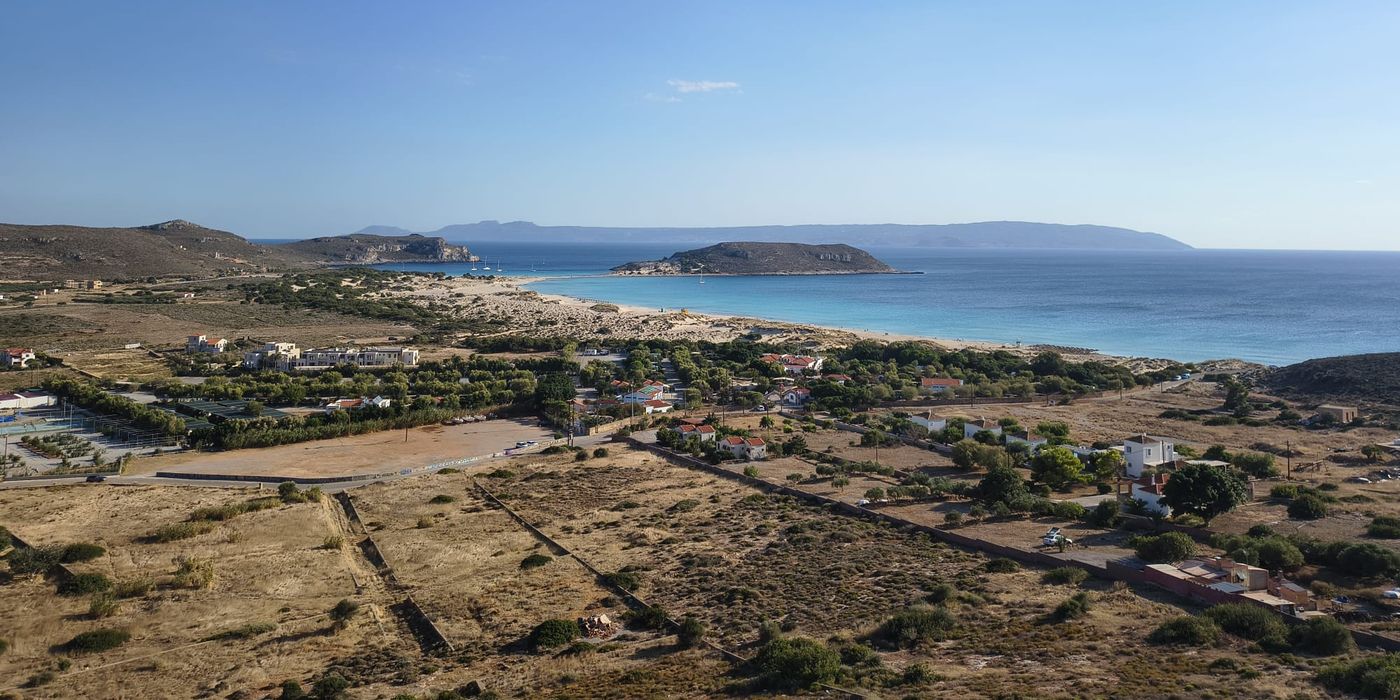Simos beach on Elafonisos, with turquoise sea, white sand dunes and a small island