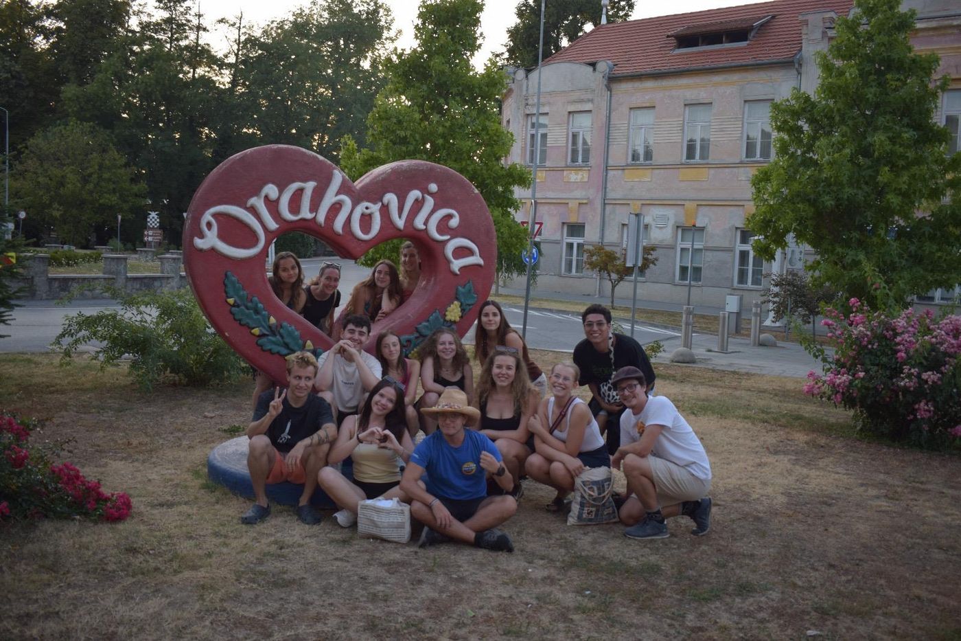 The youth exchange group posing around the big red Orahovica heart sign